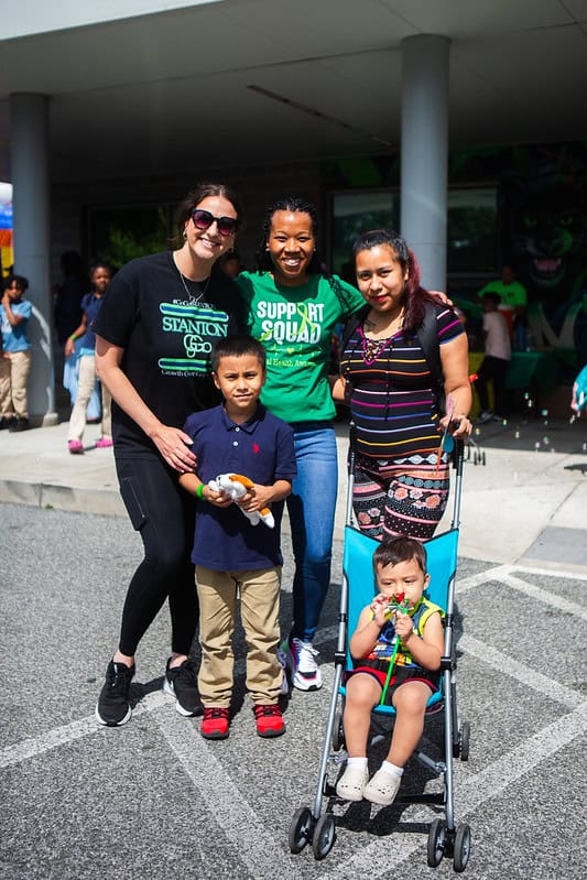 Three women posing with two children outdoors