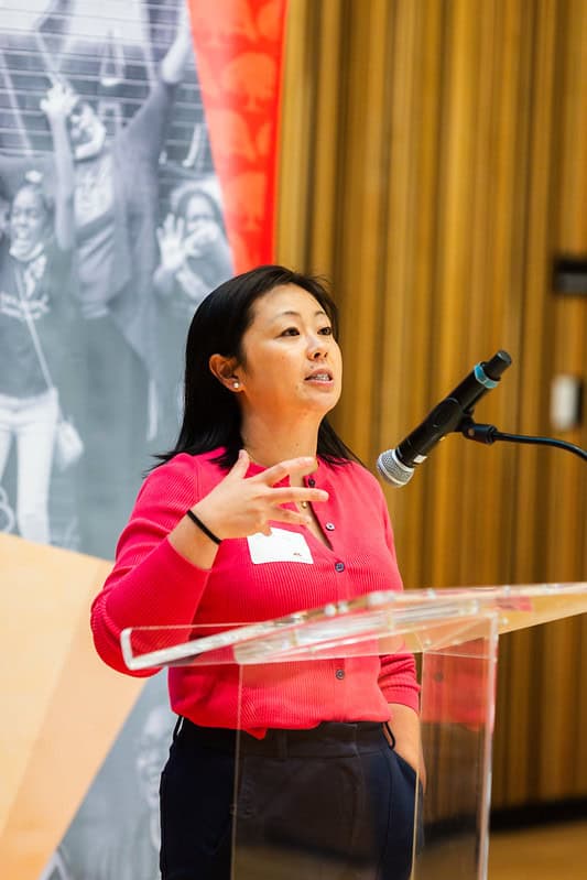A woman standing at a podium giving a speech